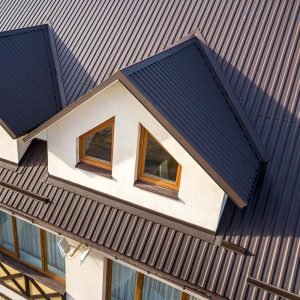 A newly built house with a metal roof stands in the evening sun of Indiana.